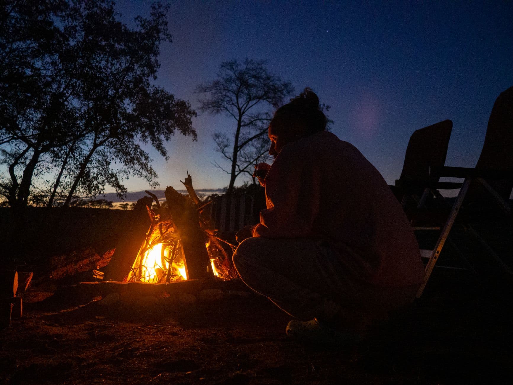 Campers around a campfire at dusk